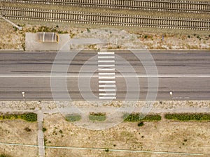 Aerial top view of crosswalk on a countryside fast speed road f