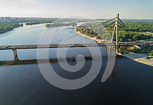 Aerial top view of Dnieper river and Moskovskiy bridge in city of Kiev