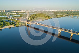 Aerial top view of Dnieper river and Moskovskiy bridge in city of Kiev