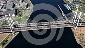 Aerial or top view from drone of concrete bridge with asphalt road or highway over big river with city car traffic