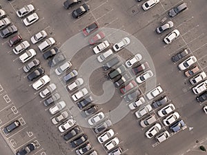 Aerial top view from drone of parking lot of the business center, shopping mall, supermarket or hospital with cars and