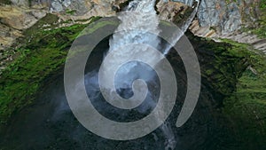 Aerial top view drone rise up and spin over Coban Sriti waterfall, Indonesia