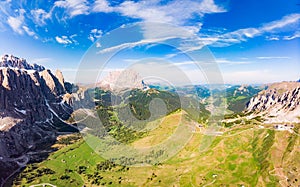 Aerial top view from drone to Col Raiser plateau In sunny summer Day. Scenery of rugged Sella Mountain with green valley on grassy