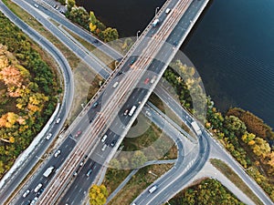 Aerial or top view from drone to road junction, freeway and bridge and car traffic in big city, urban transportation concept