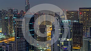 Aerial top view of Dubai Marina night to day timelapse. Modern towers and traffic on the road