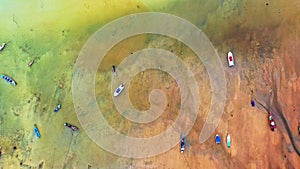 aerial top view fishing boats parking on the beach during low tide at Rawai beach Phuket Thailand