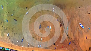 aerial top view fishing boats parking on the beach during low tide at Rawai beach Phuket Thailand