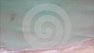 Aerial top view from flying drone sea waves slow motion video with beach