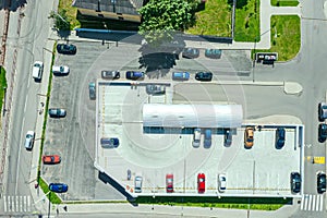 Aerial top view of garages and car parking lot in residential district of city