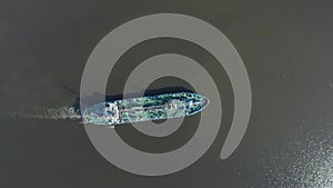 Aerial top view general small ship tugboat with tanker fuel floats in the bay of the port