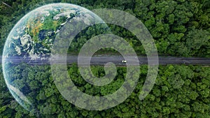 Aerial top view of green electric vehicle car driving over straight forest road, EV car electric vihicle car on forest road with