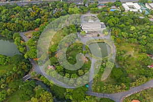 Aerial top view of green trees in Lumpini park garden and reflection. Green eco area in smart urban city at noon, Bangkok,