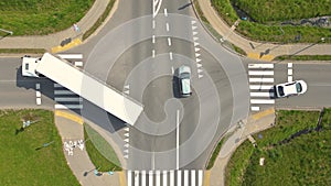 Aerial top view of highway junction interchange road. Drone view of the elevated road, traffic junctions, and green garden.