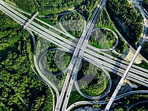 Aerial top view of Highway and overpass with green forests in Finland