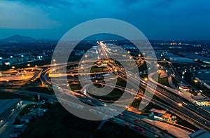 Aerial top view of Highway road junctions. Rush hour traffic on multiple highways in city at night.