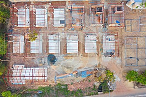 Aerial top view of homes or houses in village under construction site with structure. Top view of precast concrete slap floor.