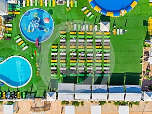 Aerial top view of hotel with swimming pool, sunbeds from above, tropical holiday resort, mediterranean paradise