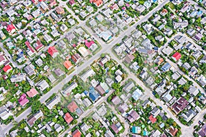 Aerial top view of houses in city suburb area in summer