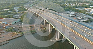 Aerial top view of huge complex road junction at cars driving on the Alfred E. Driscoll Bridge across the Raritan River