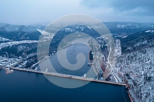 Aerial top view hydroelectric dam, water discharge through locks