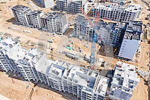 Aerial top view of industrial tower crane at construction site