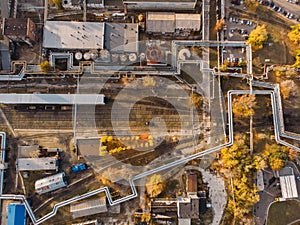 Aerial or top view of industrial zone near energy power plant or factory with warehouses, pipelines and other buildings