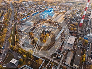 Aerial or top view of industrial zone near energy power plant or factory with warehouses, pipelines and other buildings