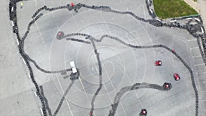 Aerial top view of the karting track made of old black car tires, motorsport concept. Media. Outdoors karting track