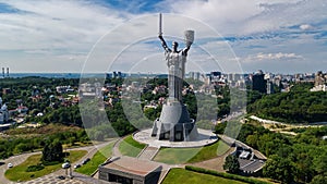 Aerial top view of Kiev Motherland statue monument on hills from above and cityscape, Kyiv, Ukraine