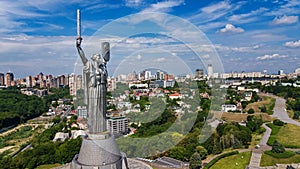 Aerial top view of Kiev Motherland statue monument on hills from above and cityscape, Kyiv, Ukraine