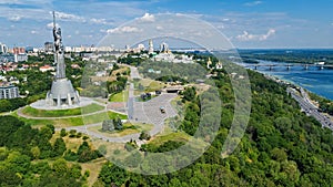 Aerial top view of Kiev Motherland statue monument on hills from above and cityscape, Kyiv, Ukraine