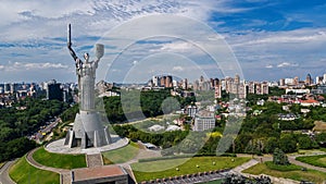 Aerial top view of Kiev Motherland statue monument on hills from above and cityscape, Kyiv, Ukraine