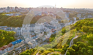 Aerial top view of Kyiv cityscape of Vozdvizhenka and Podol historical districts on sunset from above, city of Kiev