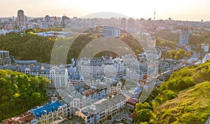 Aerial top view of Kyiv cityscape of Vozdvizhenka and Podol historical districts on sunset from above, city of Kiev