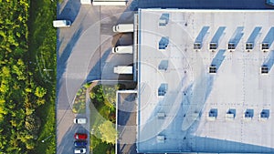 Aerial top view of the large logistics park with warehouse, loading hub with many semi-trailers trucks