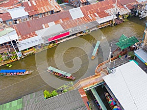 Aerial top view of local people sell fruits, food and souvenirs on boats at Damnoen Saduak Floating Market in Ratchaburi District