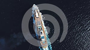 Aerial top view of luxury large cruise ship sailing full speed on open water, luxury vacation concept. Stock. Large