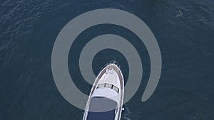 Aerial top view of a luxury white yacht and relaxing people. Clip. Concept of summer vacation, beautiful sail boat