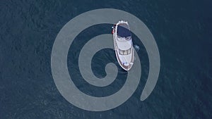 Aerial top view of a luxury white yacht and relaxing people. Clip. Concept of summer vacation, beautiful sail boat