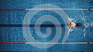 Aerial Top View Male Swimmer Swimming in Swimming Pool. Professional Determined Athlete Training for