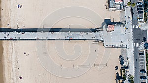 aerial top view of Manhattan Beach Pier which protrudes into the water of Pacific Ocean