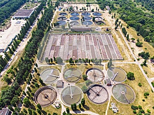 Aerial top view of modern urban sewage or wastewater treatment plant of city, drone photo