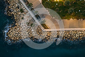 Aerial top view of Molos Park at night. Famous Limassol, Cyprus walking alley in evening, drone photo
