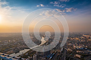 Aerial top view of Moscow city panorama at sunset, river and bridges, roads and buildings in evening myst