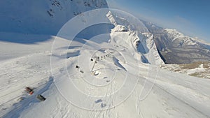 Aerial top view natural mountain snowy summit with ski resort people tourist sunny landscape