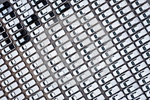 Aerial top view new cars lined up parked in a row in warehouse at the commercail dock for exporting to distributors and dealers