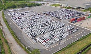 Aerial top view of new cars parking for sale stock lot row, dealer inventory import and export business commercial worldwide,