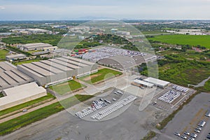 Aerial top view of new cars parking for sale stock lot row, dealer inventory import and export business commercial worldwide,