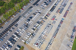 Aerial top view of new cars parking for sale stock lot row, dealer inventory import and export business commercial worldwide,
