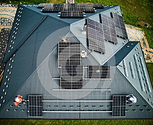 Aerial top view of new modern cottage with solar PV panels system on roof. photo